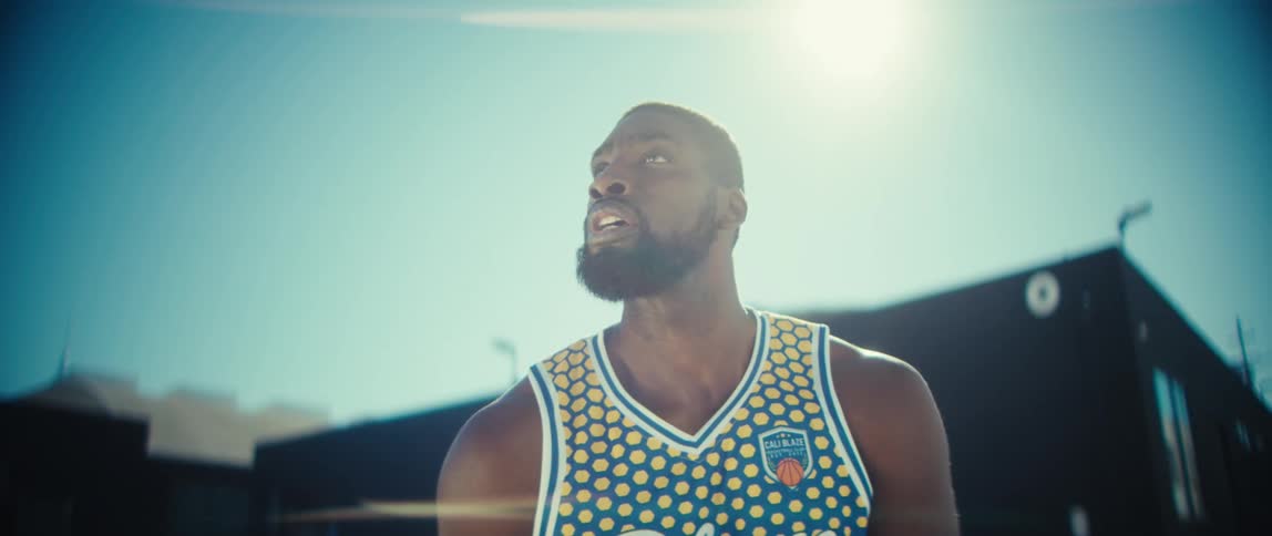 A man playing basketball outdoors
