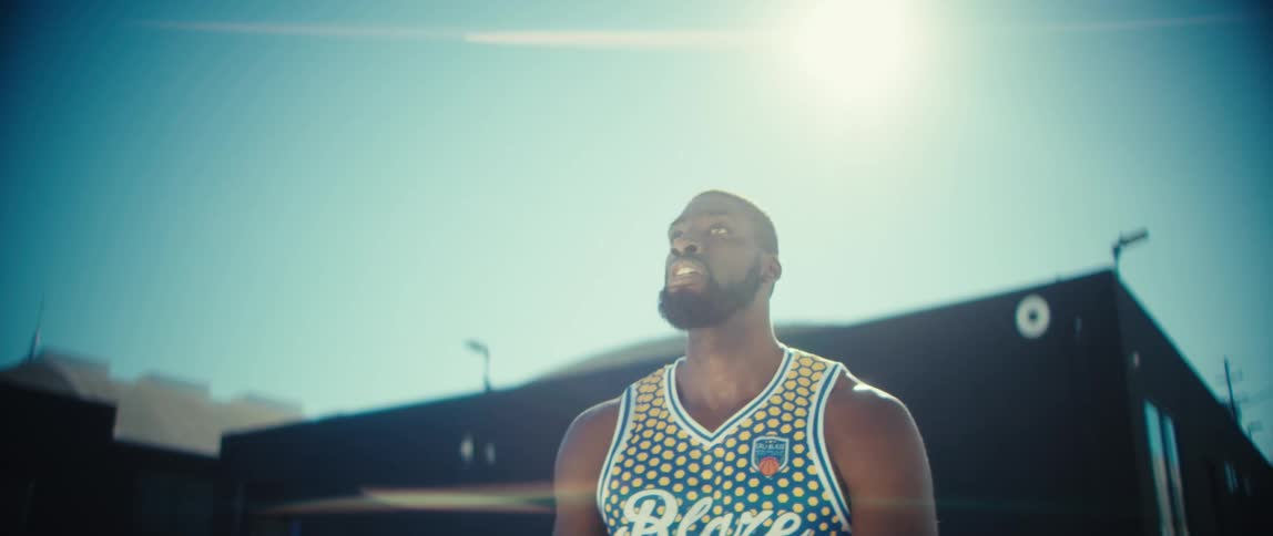 Man throwing a basketball in an outdoor area