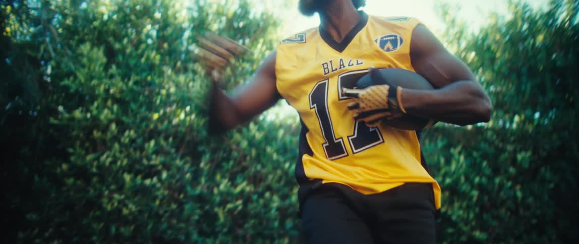 Man jumping and catching an american football
