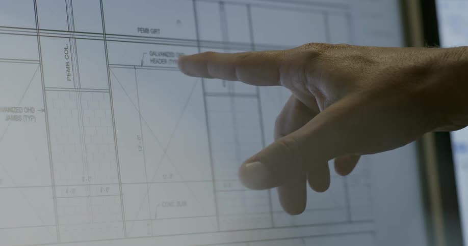 Person points to a graph on a monitor