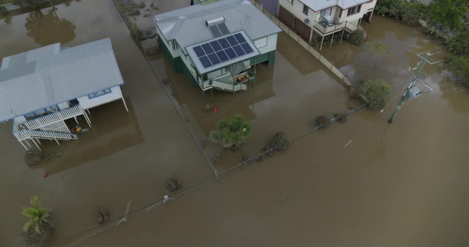 Row of houses on a street covered by flooded water outdoors during day time