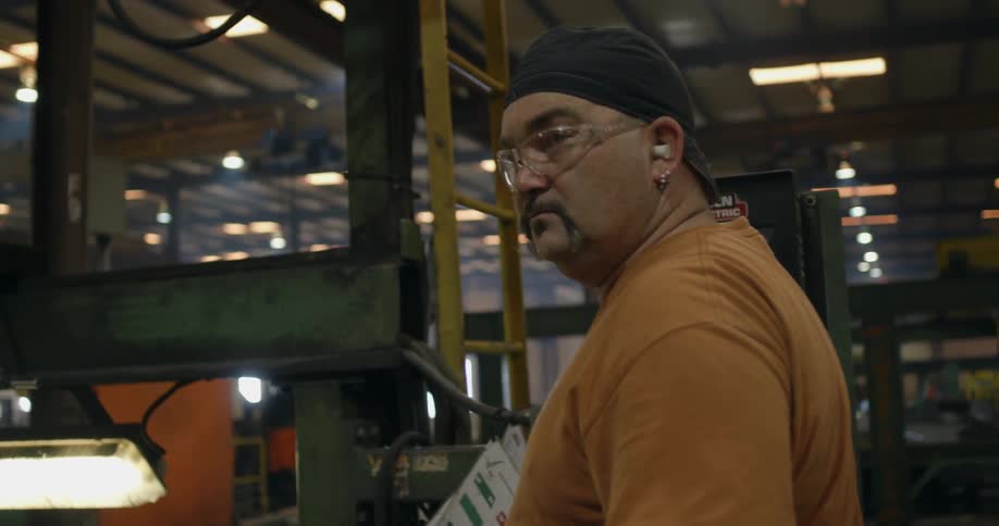 A man working with machinery in a factory
