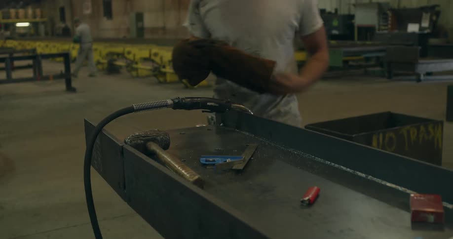 People are working in a shop with tools and torches