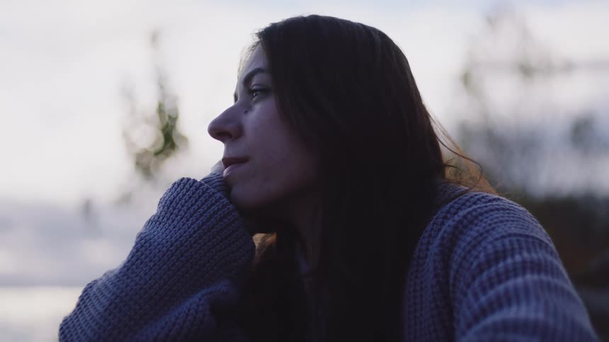 Woman is talking to a man outdoors on a cloudy day