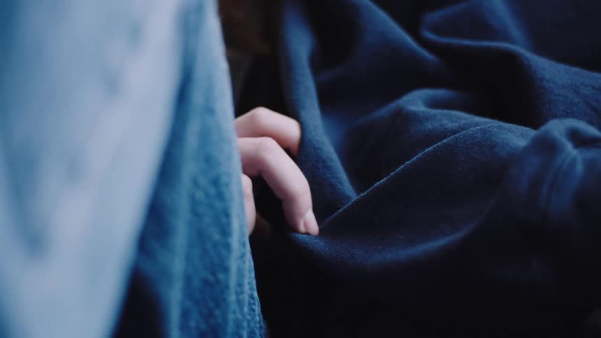 Closeup of one persons hands touching another