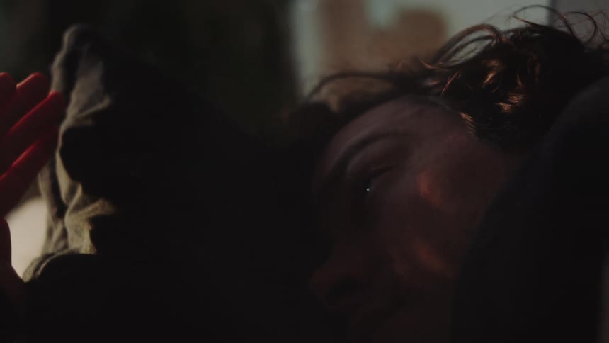 Man lying down with natural light reflecting off his face