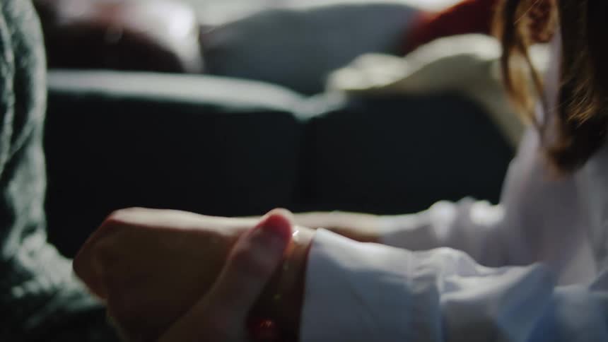 Foreheads touching with closed eyes under soft light in sunlit setting