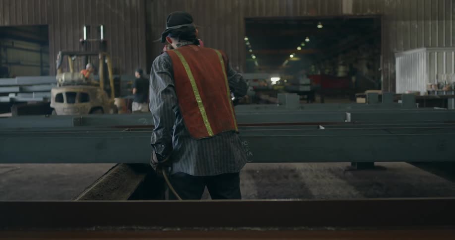 A man is spray painting metal