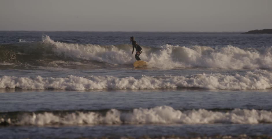 A surfer rides an ocean wave