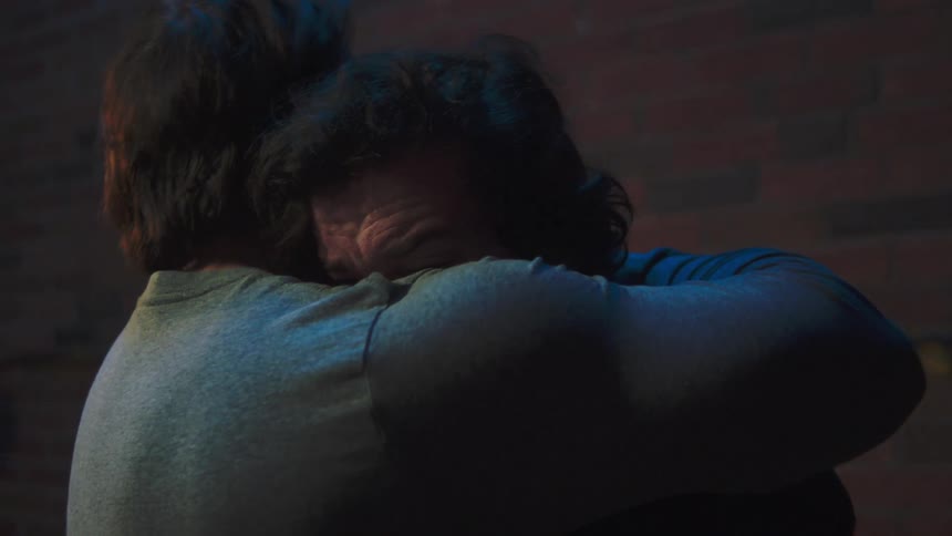 Two men hugging each other