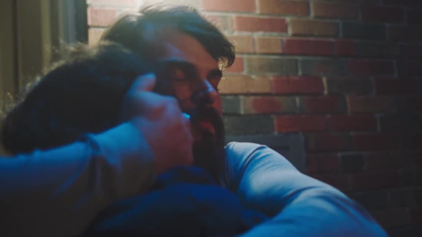 Two people embracing outdoors at night
