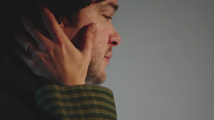 Woman placing her hands on a mans face