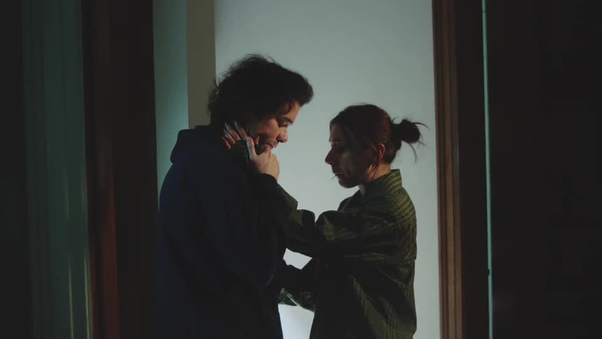 The woman touches the sad mans face