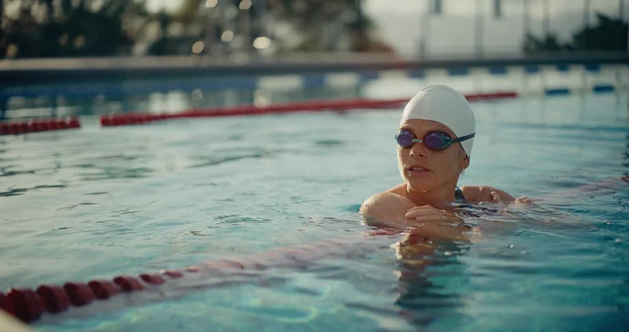 The swimmer floats in the pool
