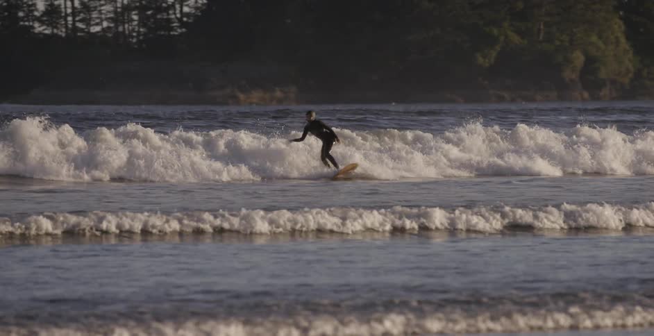 A surfer rides an ocean wave