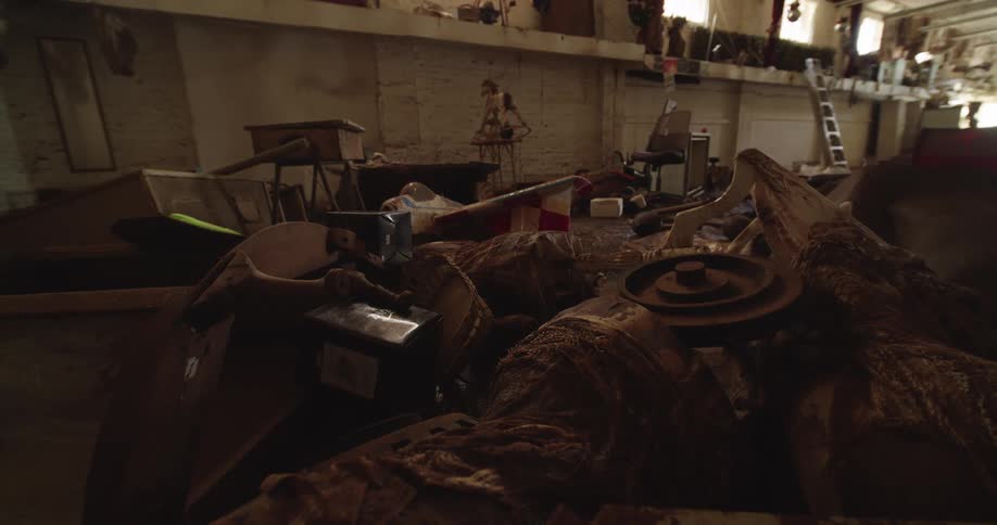 Warehouse interior filled with accumulated items old furniture and assorted equipment