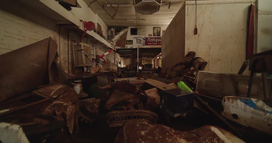 Rusty antique items fill disorganized commercial space
