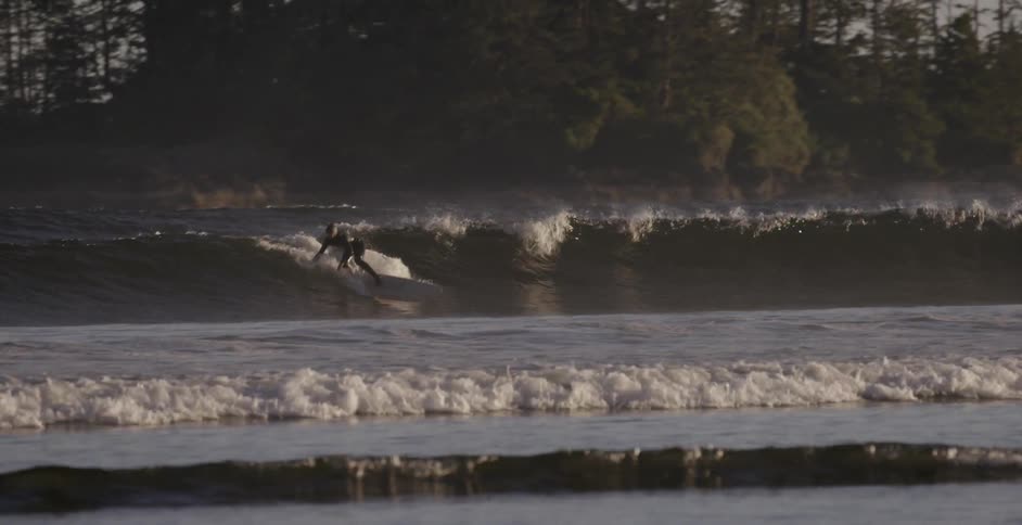 A surfer rides an ocean wave