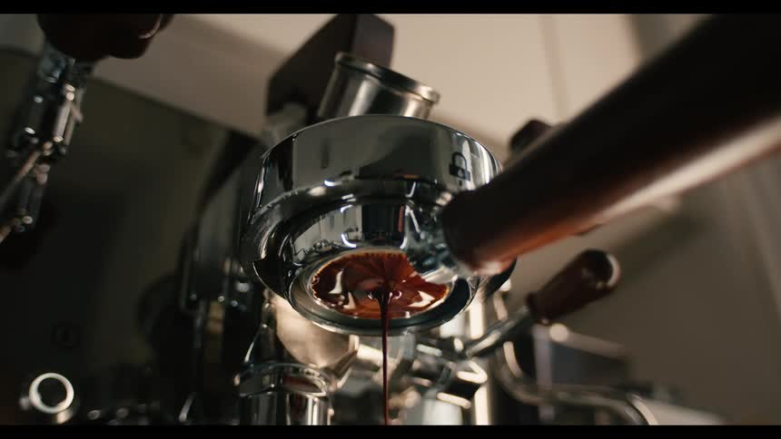 A person making espresso