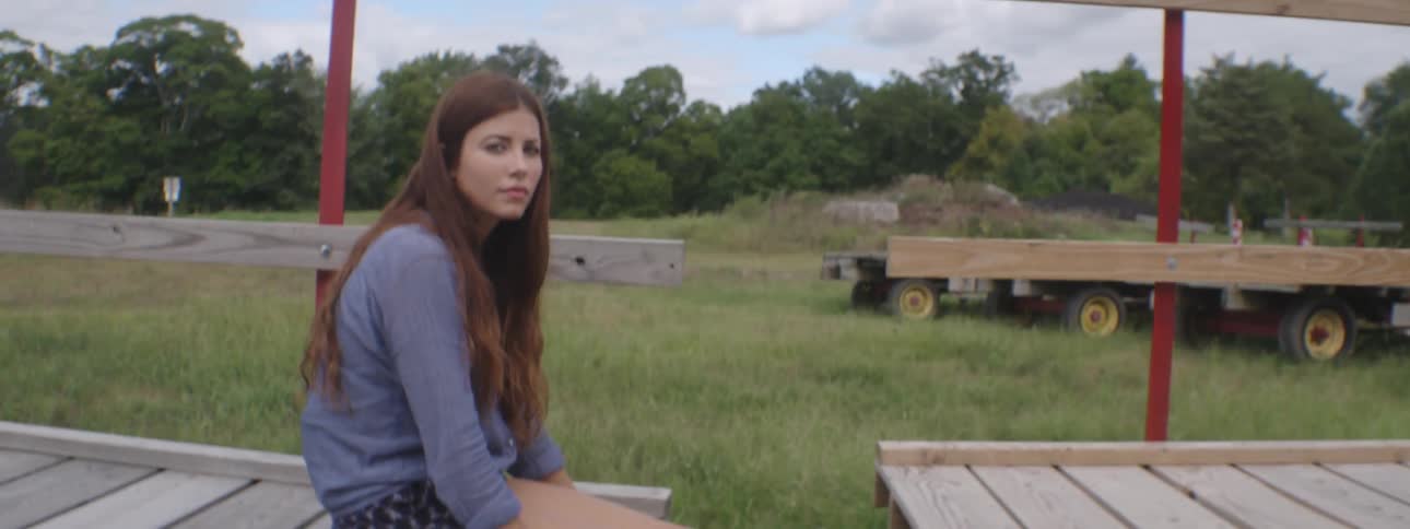 A woman sits on a trailer