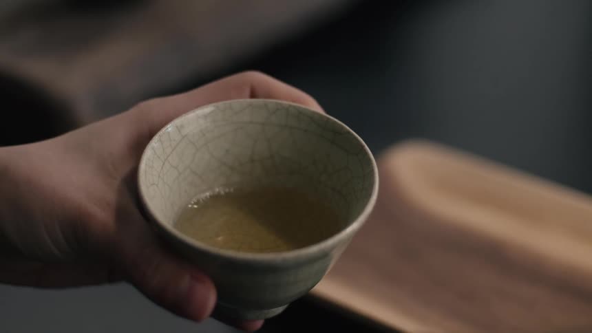 A person swirling a glass of tea
