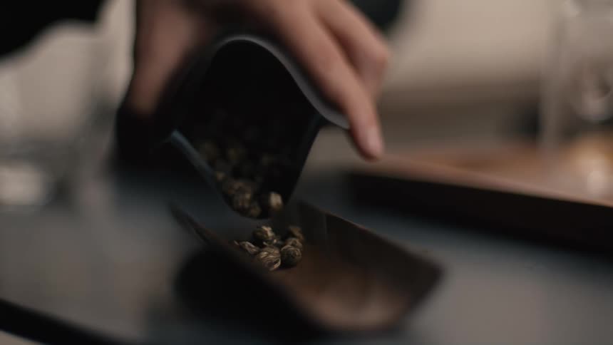 Hand pouring coffee beans