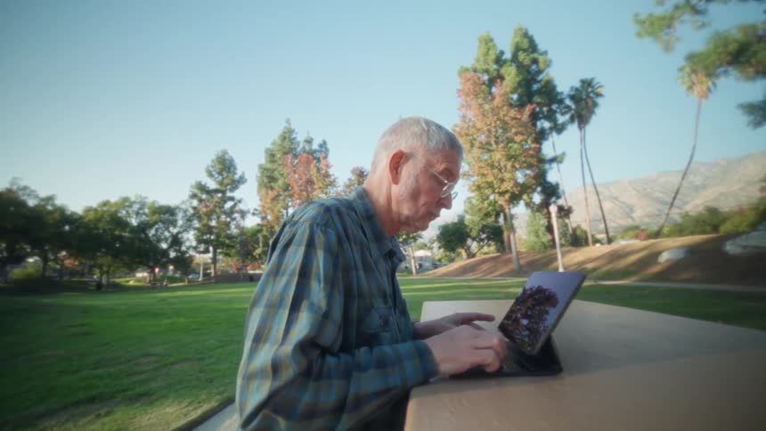 A man using a tablet outdoors