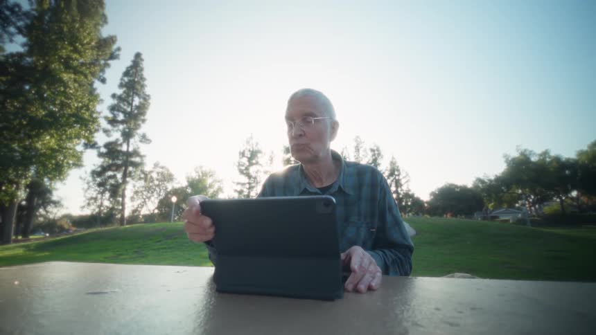 A man using a tablet outdoors