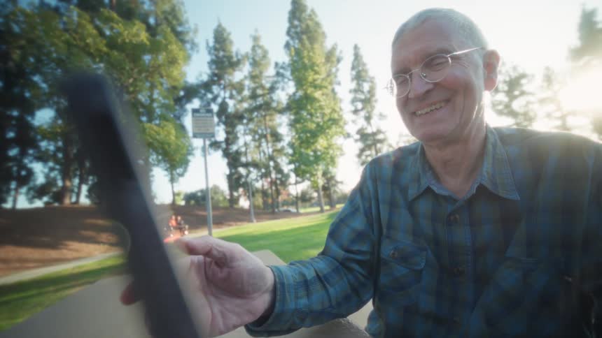 A man using a tablet outdoors