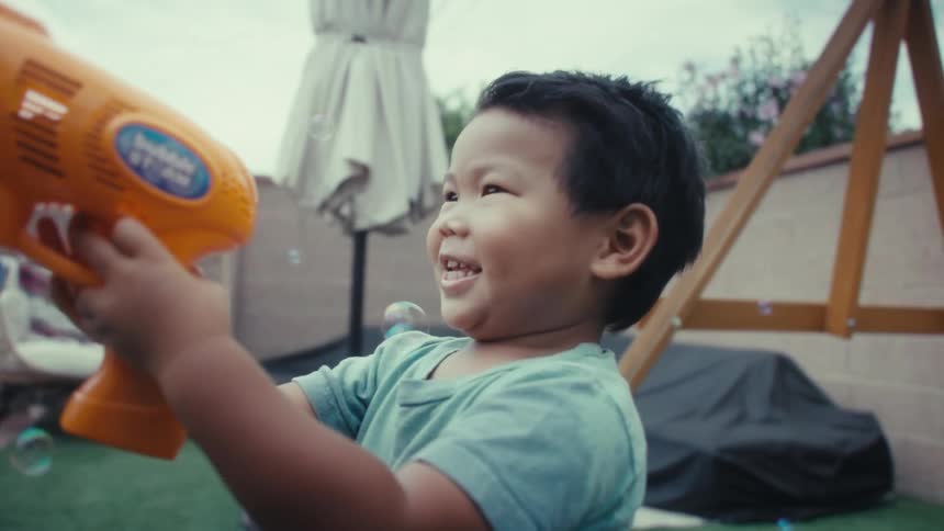 A child playing with a bubble gun