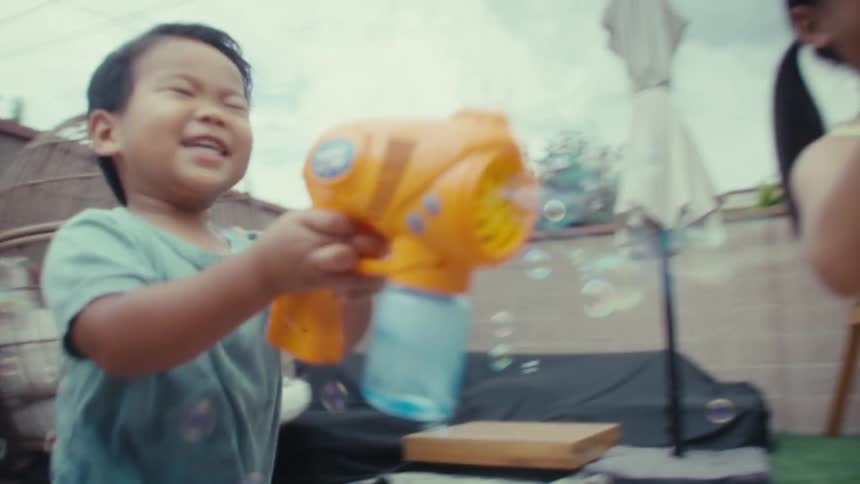Two kids playing outdoors with bubbles