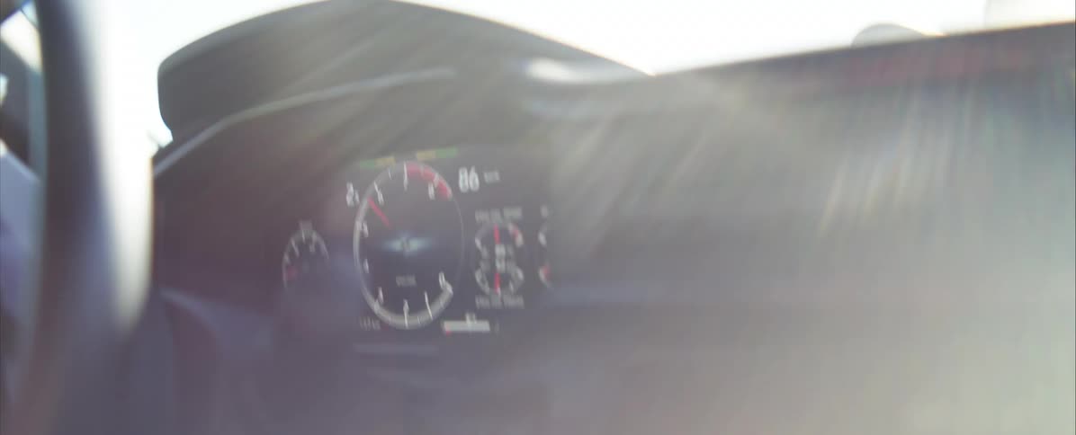 Human hands wearing gloves driving a racing car indoors during day time