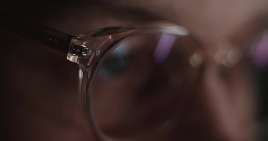 A close up of a persons eye through their eyeglasses