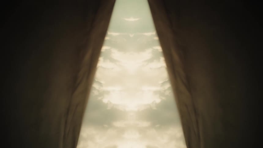 Curtains opening to reveal a bright sky in a symmetrical composition