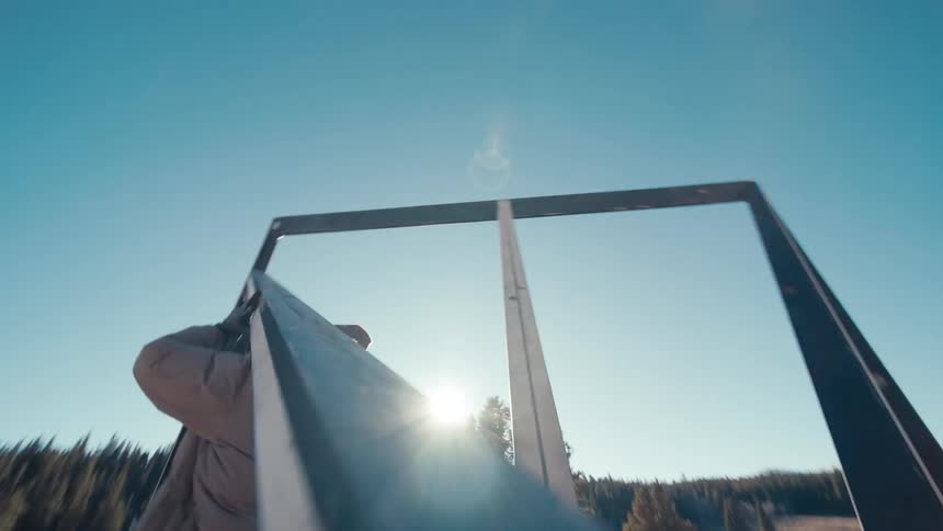 A man moving metal beams
