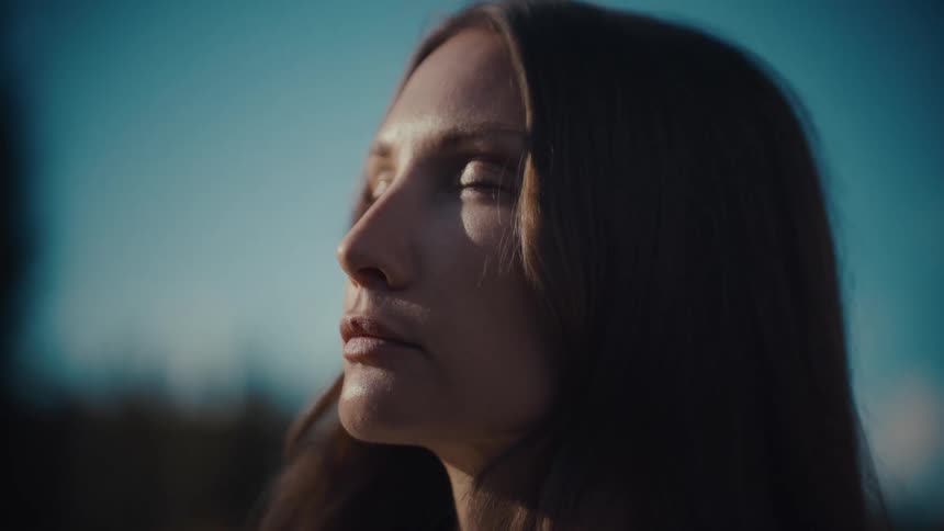 A portrait of a woman standing outdoors
