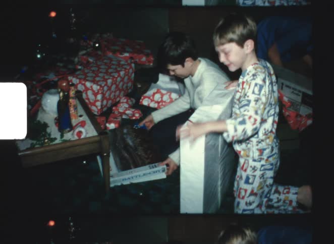 Children are happy as they open christmas gifts