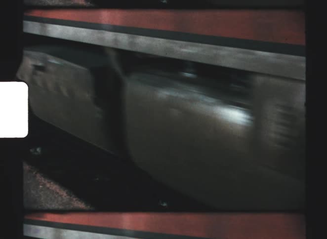 Train in motion seen up close with wheels and tracks in view