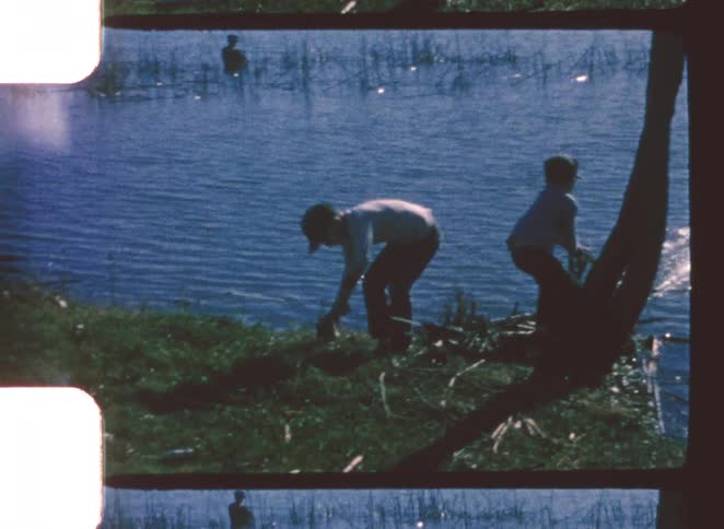 Two children fishing in a lake
