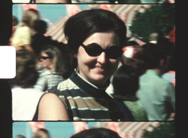Woman wearing sunglasses in a crowd in an outdoor area