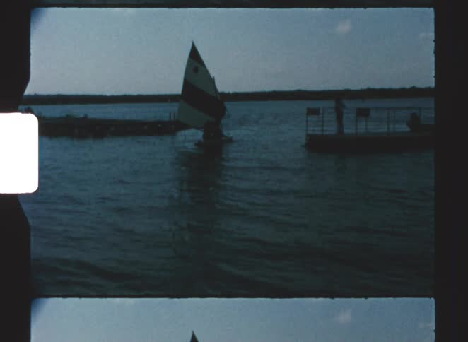 A small sailboat out on a lake