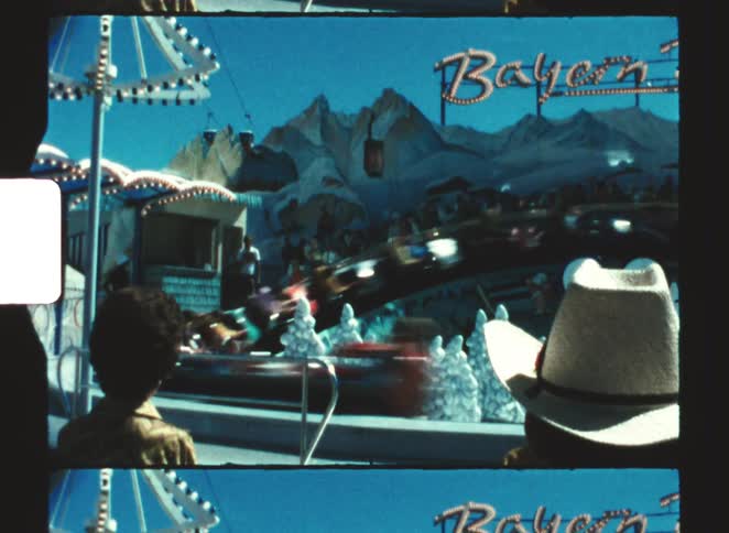 A group of peopel watching a roller coaster