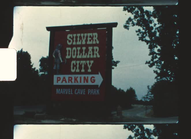 A large sign directs traffic into the park