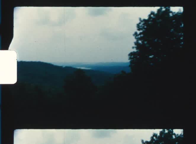 The hills are covered with green trees