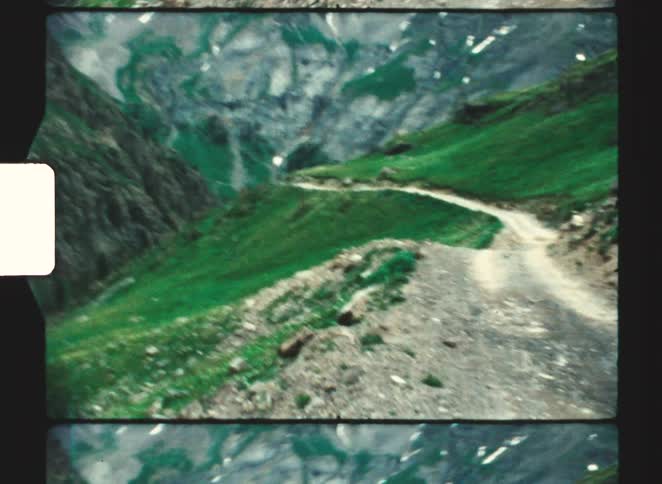 Hiking trail cuts across a mountain slope in the mountains during the daytime