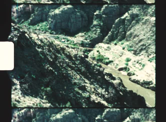 A view of a canyon with hills on either side