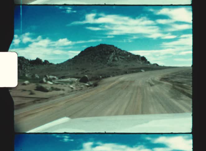 A view from a car of a dirt road