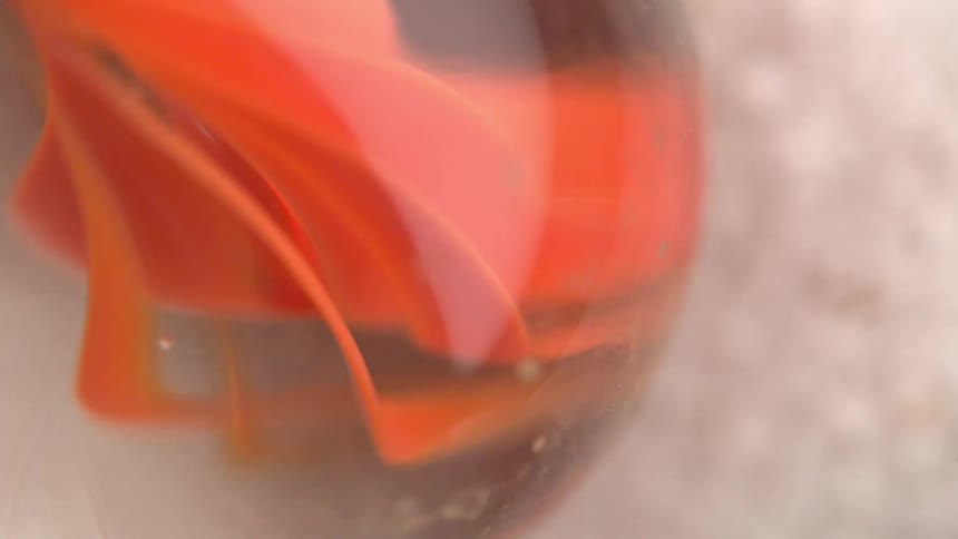 A glass sphere with orange tint inside