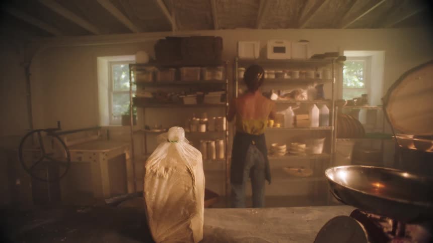 Woman wrapping a ceramic vase in a workshop