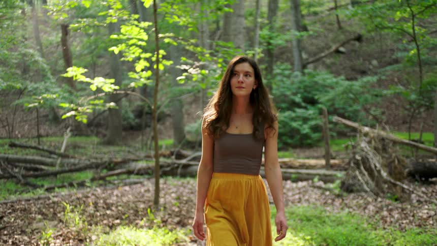 The woman is hiking in the woods